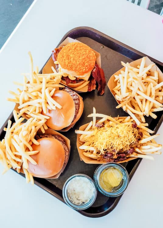 Overhead view of a tray of burgers and fries