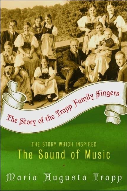Cover of The Story of the Trapp Family Singers by Maria Augusta Trapp, featuring a sepia-toned photograph of the Trapp family in traditional Austrian clothing, smiling together outdoors. A green and white banner across the cover reads, “The Story which inspired The Sound of Music.”
